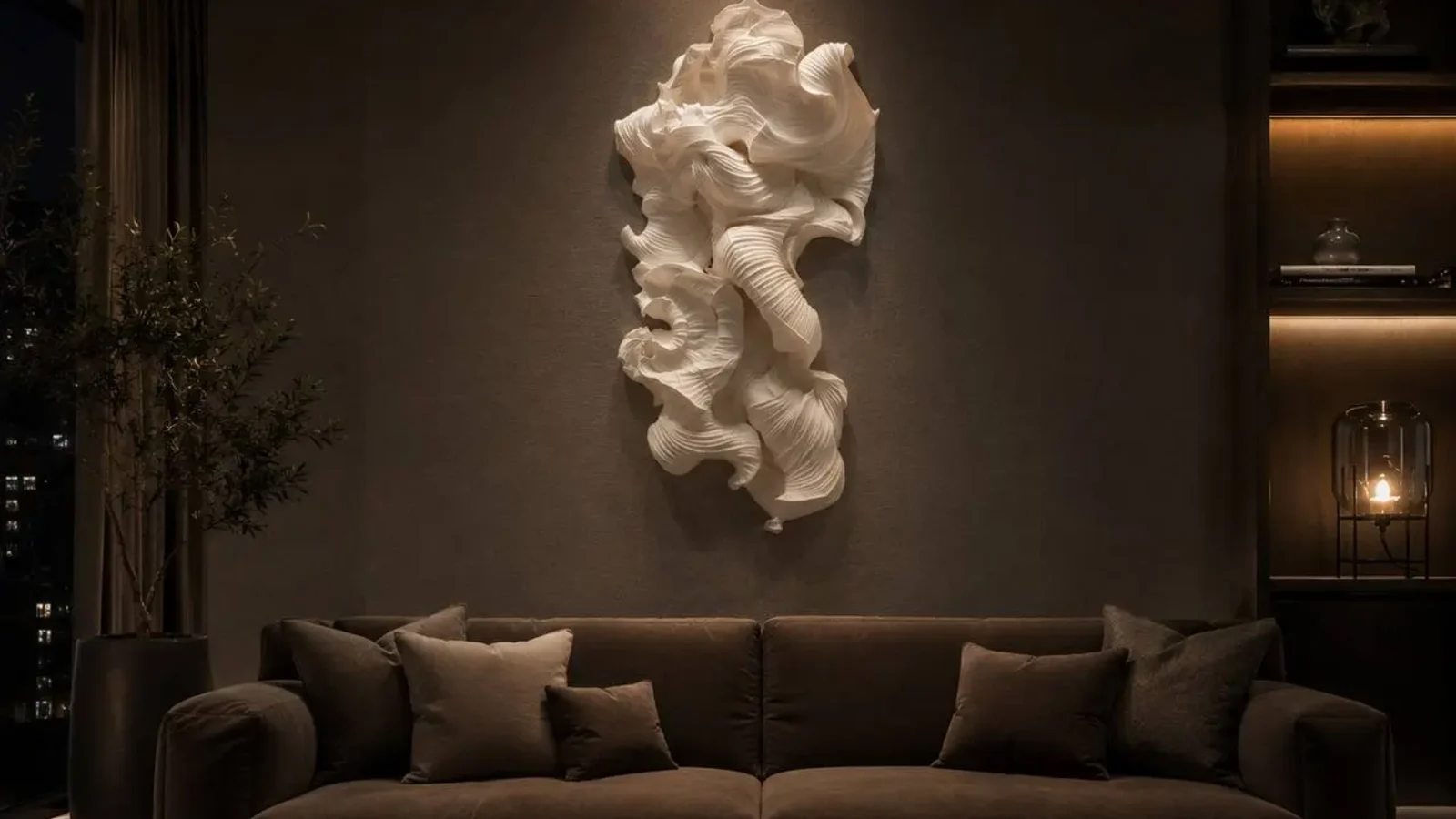 White sculptural wall artwork above a sofa