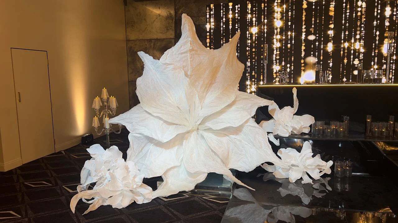 Frozen large white sculptural flower installation in an event setting